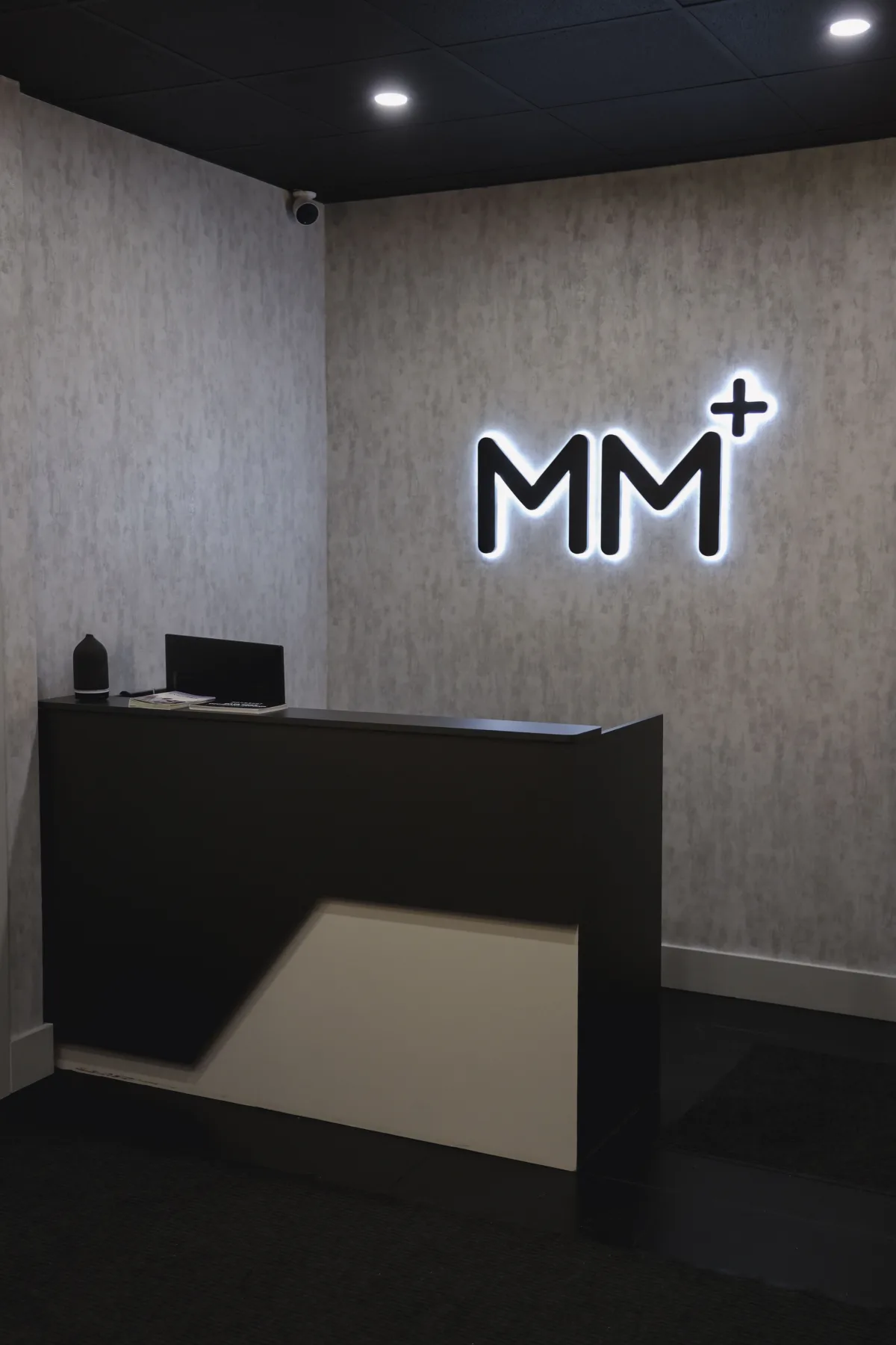 Moonshot Medical front desk with illuminated MM+ logo