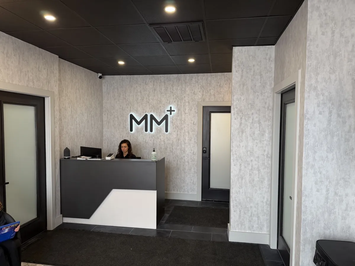 Moonshot Medical and Performance front desk with lit MM+ sign