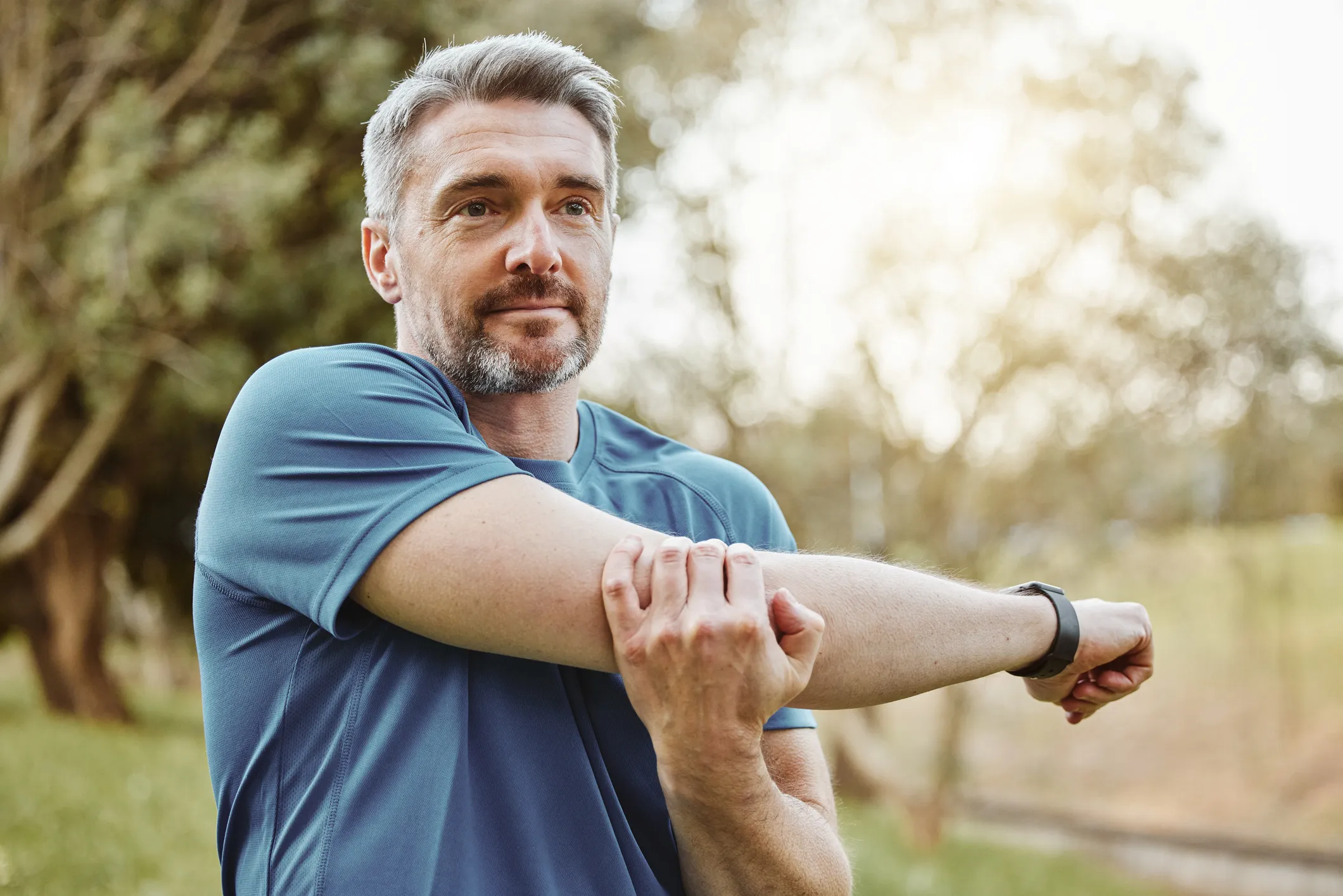 Active man stretching outdoors — pellet therapy supports energy and performance